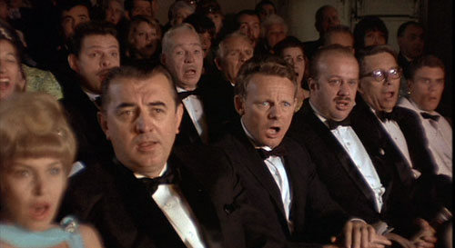 This scene from the 1967 film, "The Producers," shows audience members aghast at dancing Nazis in what was designed to be a failure of a musical to bilk investors. The moral - you don't want to be like one of these people. Do you research before investing.